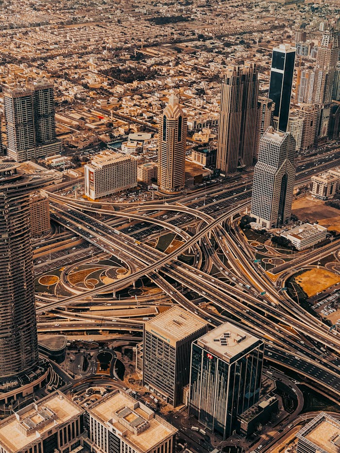 Stunning aerial shot of Dubai's skyscrapers and intricate road network.